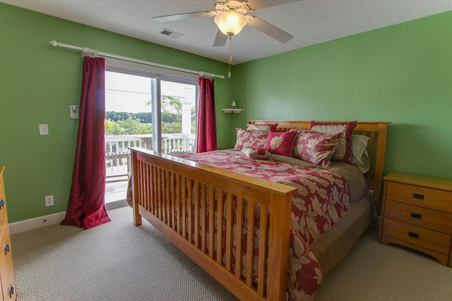 Old photo of master bedroom (walls are light blue, curtains are gray, no bedframe, white bedding) - Room Available in Whitney Lake Townhome