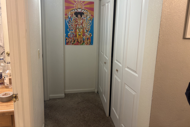 hallway with bathroom and washer dryer behind the white double doors - Bedroom for rent, duplex unit right by campus and the UMC