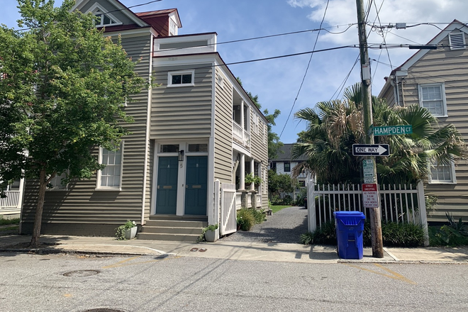 Outside front & driveway side w/ parking area beyond - 3-bed, 2-bath, off-street parking, w/d in unit