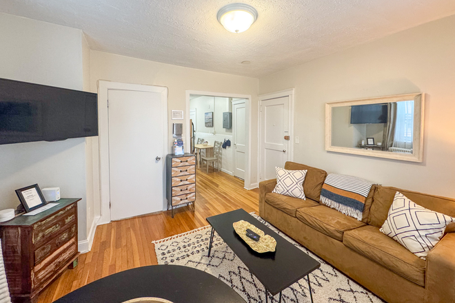 Living Room: TV Mounted to the wall on adjustable mount making it easy to see TV from all Angles - KEN1915 Renovated, Furnished 1-Bed in Longwood Medical Area Apartments