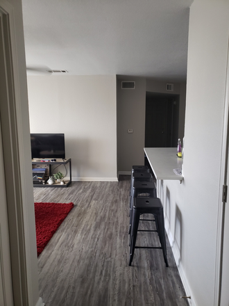 Entering kitchen and living room - University Trails, 5 minutes from campus, low rent costs with covered parking, includes gym and pool