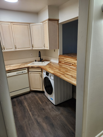 Kitchen with washer/dryer and new counter top - Cherokee at Westcliff Condo