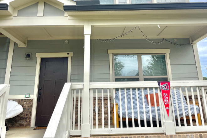 Frontdoor covered patio, with comfy chair and futon! - The Station Apartment, close to football stadium and Lenovo arena