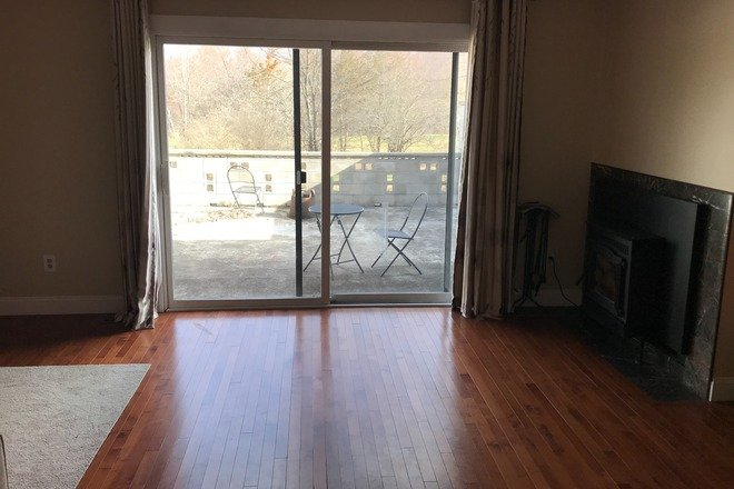 Living room with padio view - Bedroom for Rent—Winston Court near Old Belchertown road and Hampshire Athletic Club Apartments