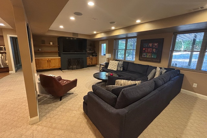 Living Room w/ fireplace and 75" TV - Stunning 1,800 sq. ft. 1-bd/1 bath, Walkout Apartment - Fully Furnished, All Utilities Included