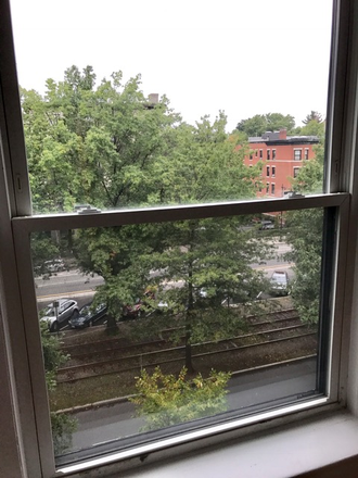 Visit hubrealtyproperties.com - Beautiful studio with a large window, front views and on the green line T Apartments