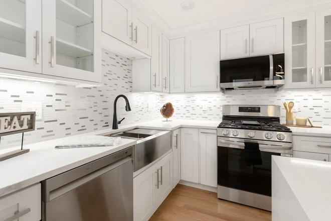 Gourmet chef's kitchen with brand-new stainless appliances and custom cabinetry. - Steps to Tufts: Sunny 4-Bed at 157 Boston Ave Condo
