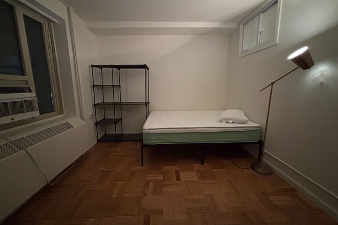 bed and portable closet - Bedroom in Stuytown Apartments