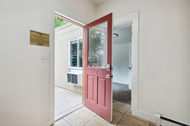 front door leading into kitchen and bedroom - house