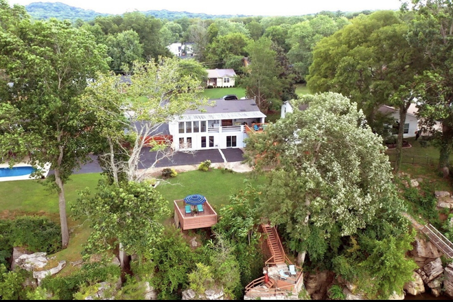 View from drone showing back of house/back yard. - River Front Luxury! Newly Renovated 5 bed/4 bath/2 kitchens. Avail: 2026 School Year House