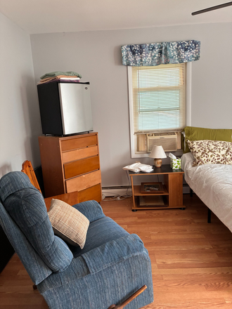 Sitting area with Lazy Boy, mini fridge, and dresser - Furnished bedroom with private bath.  We welcome short or long stays. House