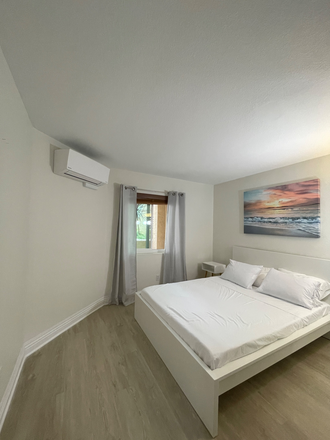 Bedroom with queen size bed with AC unit - Fully Furnished La Jolla Condo 5 min to UCSD