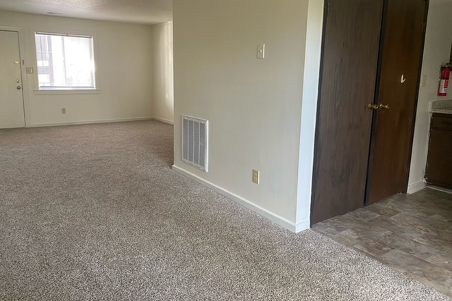 View of living room and laundry closet from dining room - Cypress Gardens Apartments