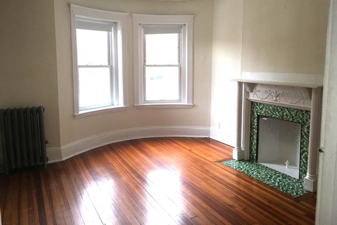 Visit hubrealtyproperties.com - Handy front facing one bedroom split with decorative fireplace, in Allston