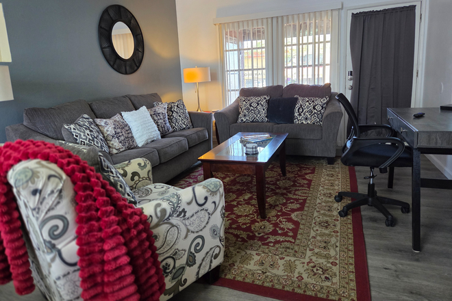 Comfy living room with cushioned area rugs. - 2-Bdrm condo 5 mins from UofA, all utilities included, wi-fi, in-unit washer/dryer, covered parking
