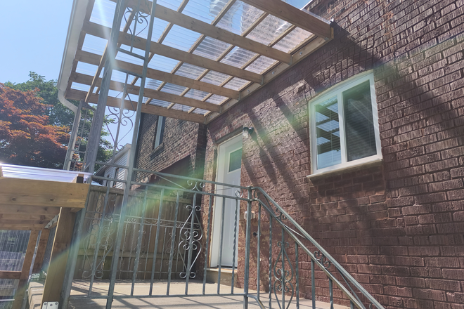 Rear deck - Furnished 3-Bed, 1.5-Bath New-build Home in Danforth Village - Steps to Greenwood Stn, Util Incl
