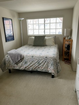 bed area of the bedroom - Large, furnished one-bedroom with sitting area and private bath, located in gated community
