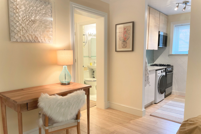 Desk and kitchen view - Bright furnished studio +den apt (incl. utilities, washer, parking)