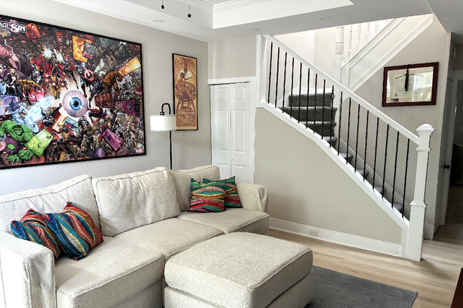 Living Room - Brand-new Lovesac Couch, Bookshelf, 65" Smart TV (Apple AirPlay + streaming services ready) - Furnished! House In Hampden, Baltimore - The Greatest Place to Live!