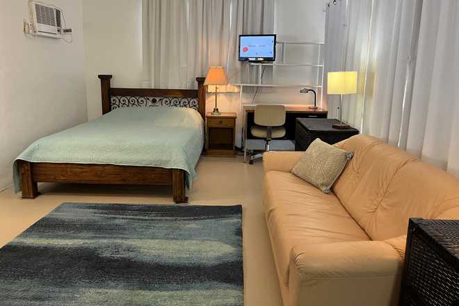 Bed area view - LRG STUDIO 1mile from campus on wooded acre, utilities, pool, parking