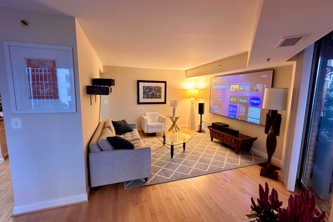 Living room with 100" HD projector  (decor is modern, as you can probably gather) - Fully Furnished 2-bed/2-full bath corner unit in Downtown Bethesda across from Bethesda Metro Condo