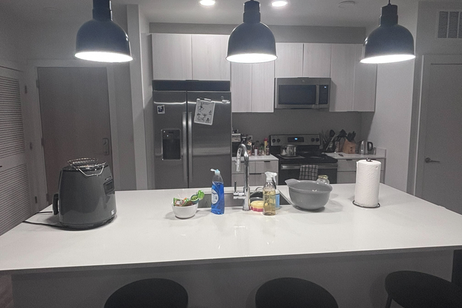 kitchen with laundry on left - The Hub Apartments