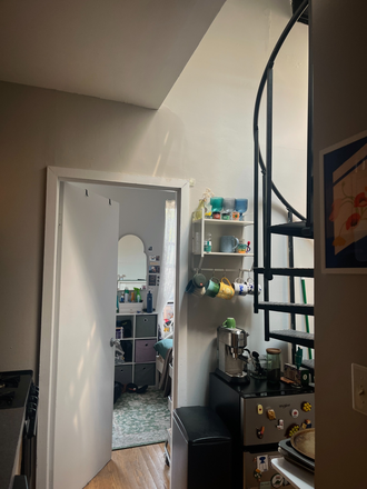 Kitchen with spiral staircase and extra fridge - East Village Apt with Private Roof Deck; 2 Bedroom, 1 Bathroom