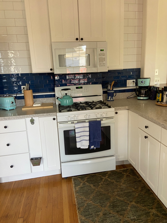 Kitchen with gas range, dishwasher, fridge, washer/dryer and appliances - Historic, designer-furnished 2 bedroom home available for spring 2026