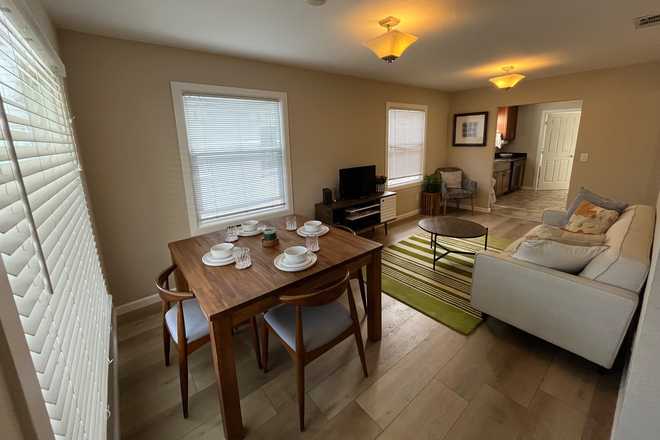Living and dining room- 4 person dining table and chairs, couch, coffee table tv etc - Amazing NOBE Location, Immaculate 2/1 Home for Rent. Garage, Yard, New Appliances, Close to Shops.