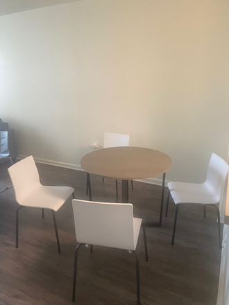 Provided table and chairs in the common area. - University View Apartments