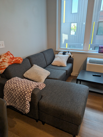 Couch in common area. - Flock 13 Apartments