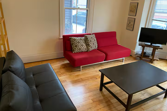 living room with couch - Fully furnished first floor apt. in Harvard Square including all utilities.