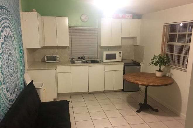 Sofa, dinning table and Kitchen area. It has 2 medium wndows - Furnished 2 room efficiency with living area in South Miami, 5 min from UM