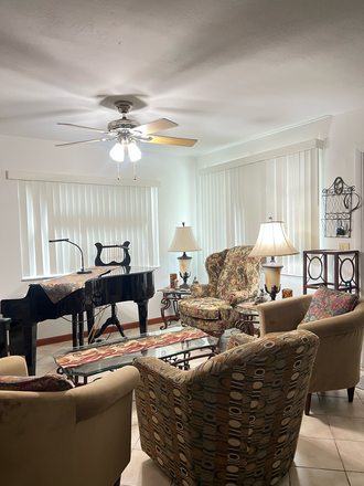 Living room with piano and fireplace - Clean Quiet Room with Private Bath