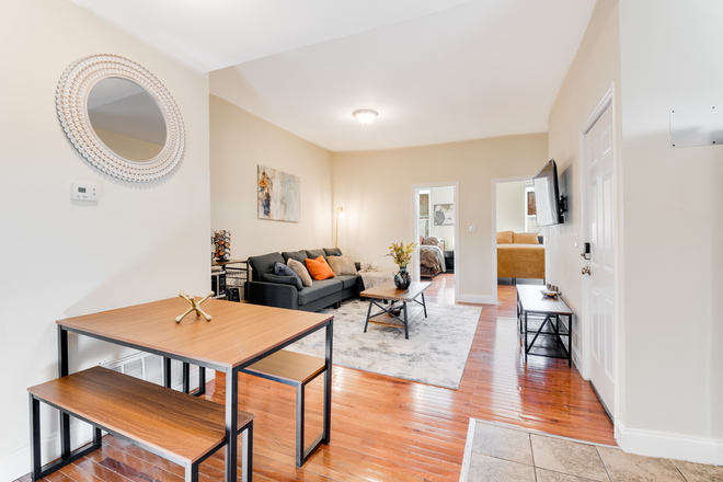 Living Room and Coffee Bar - Secure, Furnished Individual Bedrooms Available Near JHU Shuttle Stop & Penn Station Apartments