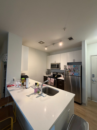 Kitchen with fridge, microwave, oven, dishwasher - Landmark 4x4 Apartment