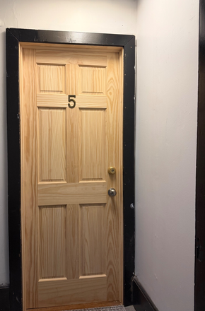 Door into apartment space being subleased - SPRING UNIT RENTAL in PRIME location:PRIVATE bedroom, shared bath/living/kitchen (in house downtown)