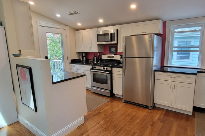 Kitchen with back entrance - Flexible dates, Charming 1-2 bed condo near universities, transport, grocery, and dining
