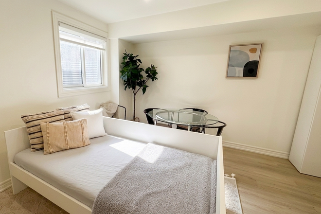 Sofa bed and egress window - Bright Furnished 1BR | 750 Sq Ft | All-Inclusive | Near Lansdowne Station Duplex