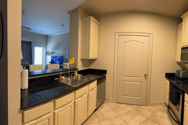 kitchen with in unit laundry in closet - Discounted rent at Houndstooth Condos for sub lease-mid December 2025-July 2026