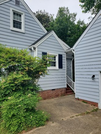 Garage and rear entrance of the house. - 1 bedroom available June 1, 2026 in clean, cozy, near campus house, all-female current residents
