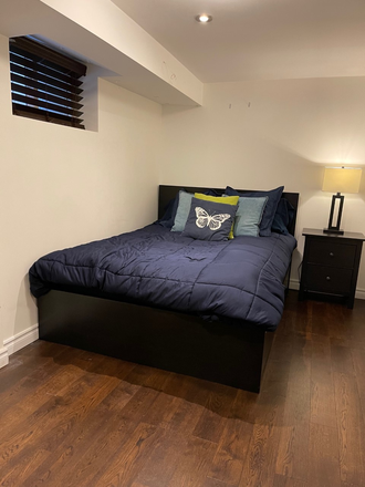 Bed, nightstand, and lamp - 1 Furnished Bedroom in the Annex — less than a 10 minute walk to St. George!