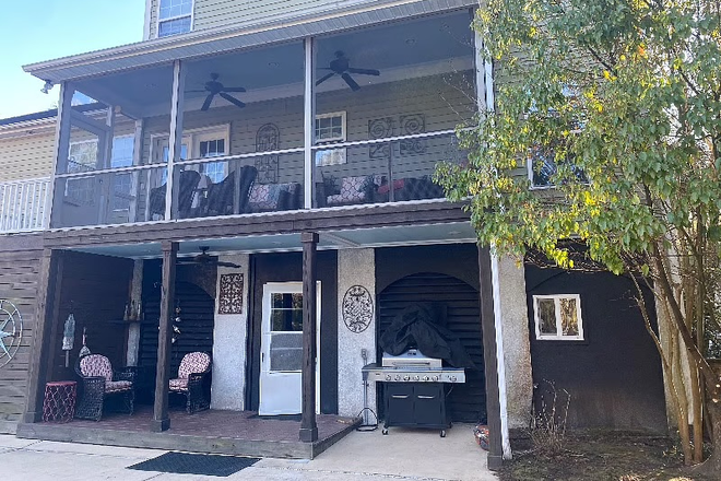 Back screened in porch and patio - Master bedroom suite available for rent in house with a pool