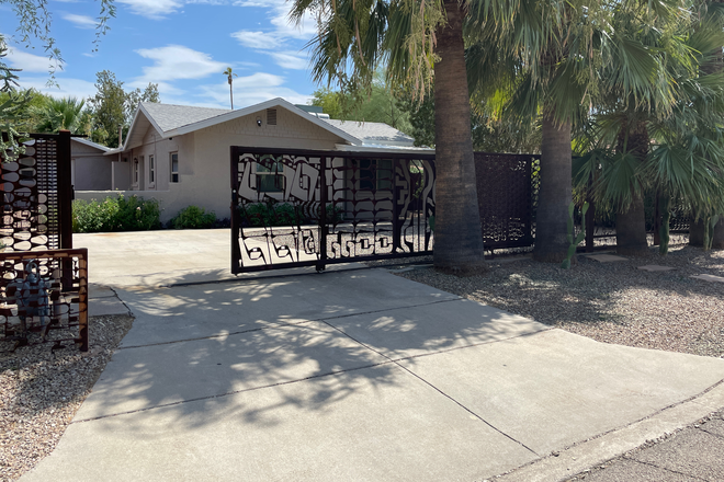 Front of house with security gate - 4 bedroom 3 bath home in Hedrick Acres