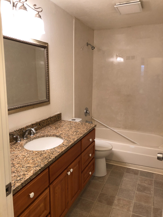 Bathroom  Shower tub, sink with vanity, toilet - 1948 Harris Street Apartments