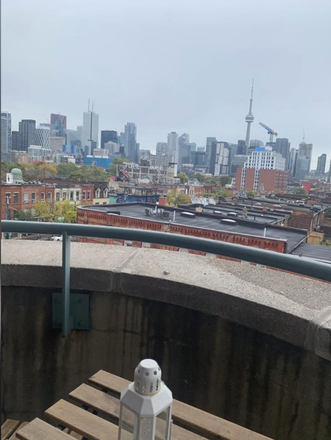 Balcony view - Furnished spare bedroom in an empty apartment in Kensington Market with CN tower view.