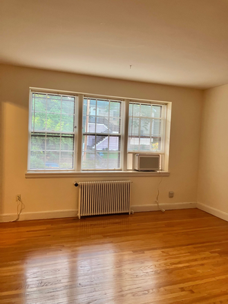 Living room at dusk - Spacious 1 bd w/PARKING on Brighton/Brookline border - 1.3 mile walk to campus Condo