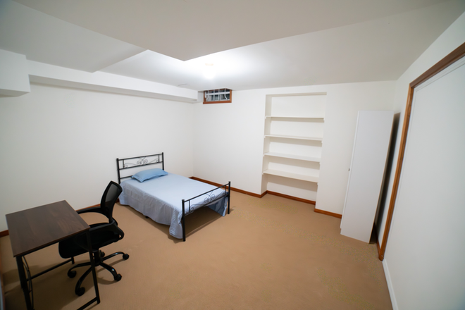 Bedroom 1 with bed, table, chair and storage shelves - 2 Furnished Bedrooms-Large Dine-in Kitchen, Amenities, washer/ dryer WiFi and dining table included House