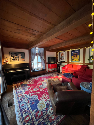 Living room with 57" TV, Yamaha piano, two couches (including a queen sleeper) - Private Furnished Treetop 3 bed 2.5 bath house for rent. Available late Aug 2025 for 1-2 semesters