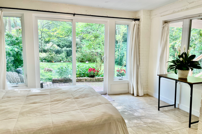 Bedroom with lots of South facing windows - Sunny Garden Apartment in Palisades Neighborhood